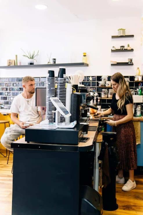 Pearl Lemon Cafe Barista holding fresh iced coffee